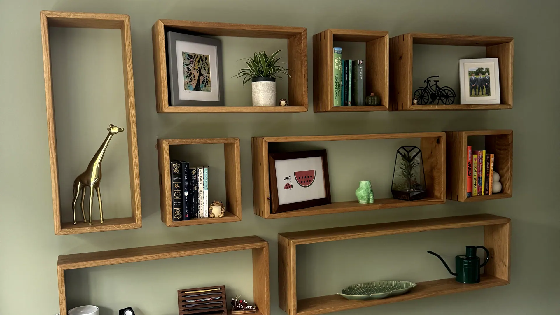 A wall of eight open oak shelving boxes