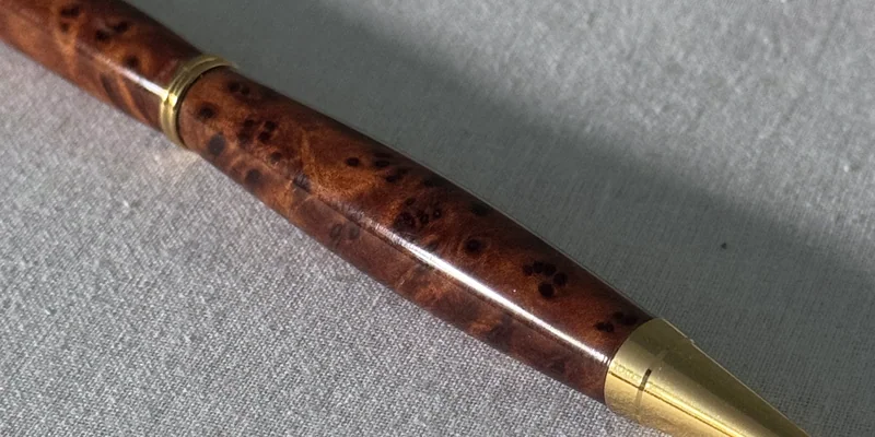 Close-up of a hand-turned pen in Amboyna