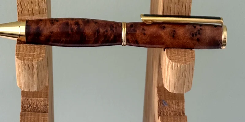 A hand-turned ballpoint pen in Amboyna