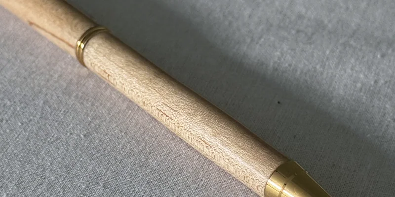 Close-up of a hand-turned pen in Maple