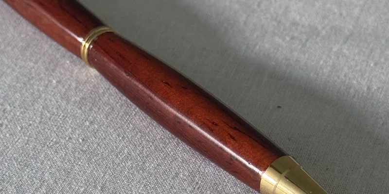 Close-up of a hand-turned pen in Padauk