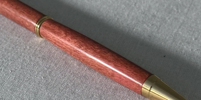 Close-up of a hand-turned pen in Pink Ivory