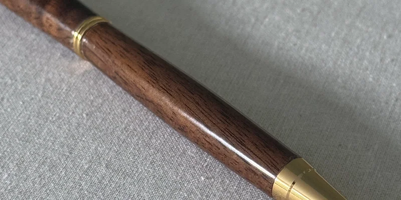 Close-up of a hand-turned pen in Walnut