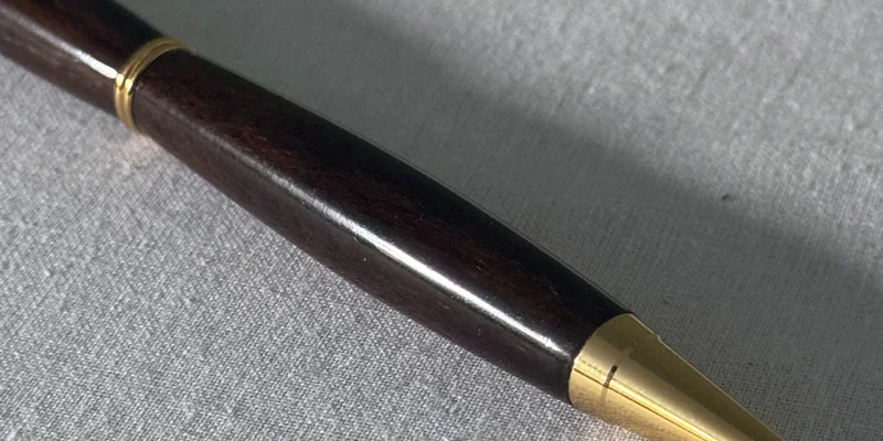 Close-up of a hand-turned pen in Ziricote